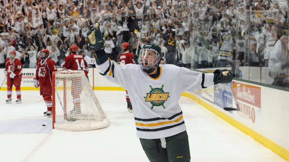 Laker hockey player celebrates along with Oswego fans