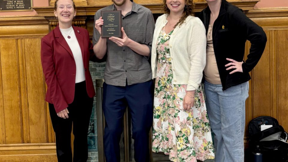 Kevin Bachmann and colleagues celebrate an award for innovation in support of students