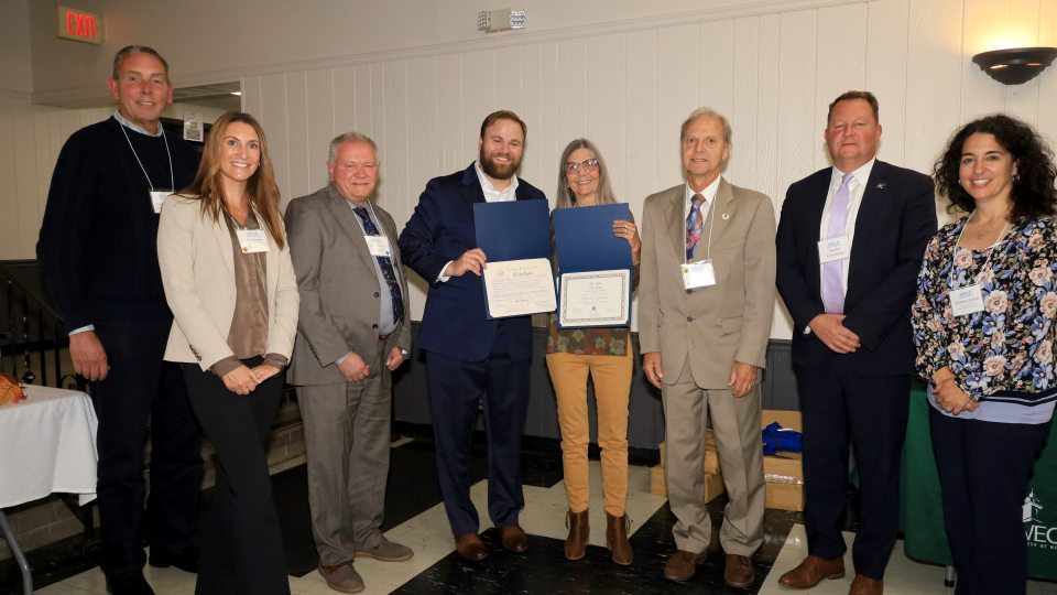 Celebrating outstanding achievements of SUNY Oswego’s Retired and Senior Volunteer Program (RSVP) of Oswego County and its members are from left, Patrick DeWine of United Way of Greater Oswego County, Kara Jones of SUNY Oswego, Fulton Mayor Jim Rice, RSVP Director Ryan Gillette, Lifetime Award Recipient Deborah Halliday, Oswego Mayor Robert Corradino, State Senator Chris Ryan and Brittney Jerred of Assemblyman Will Barclay's office. Photo by Sandy Swiech for iHeart Oswego.