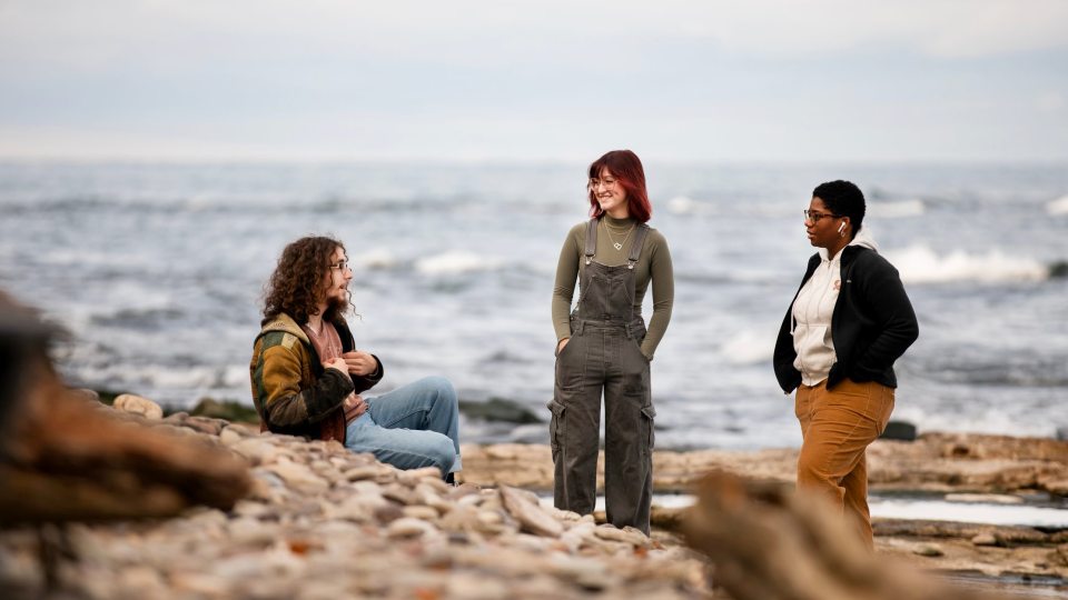 Students talk next to Lake Ontario