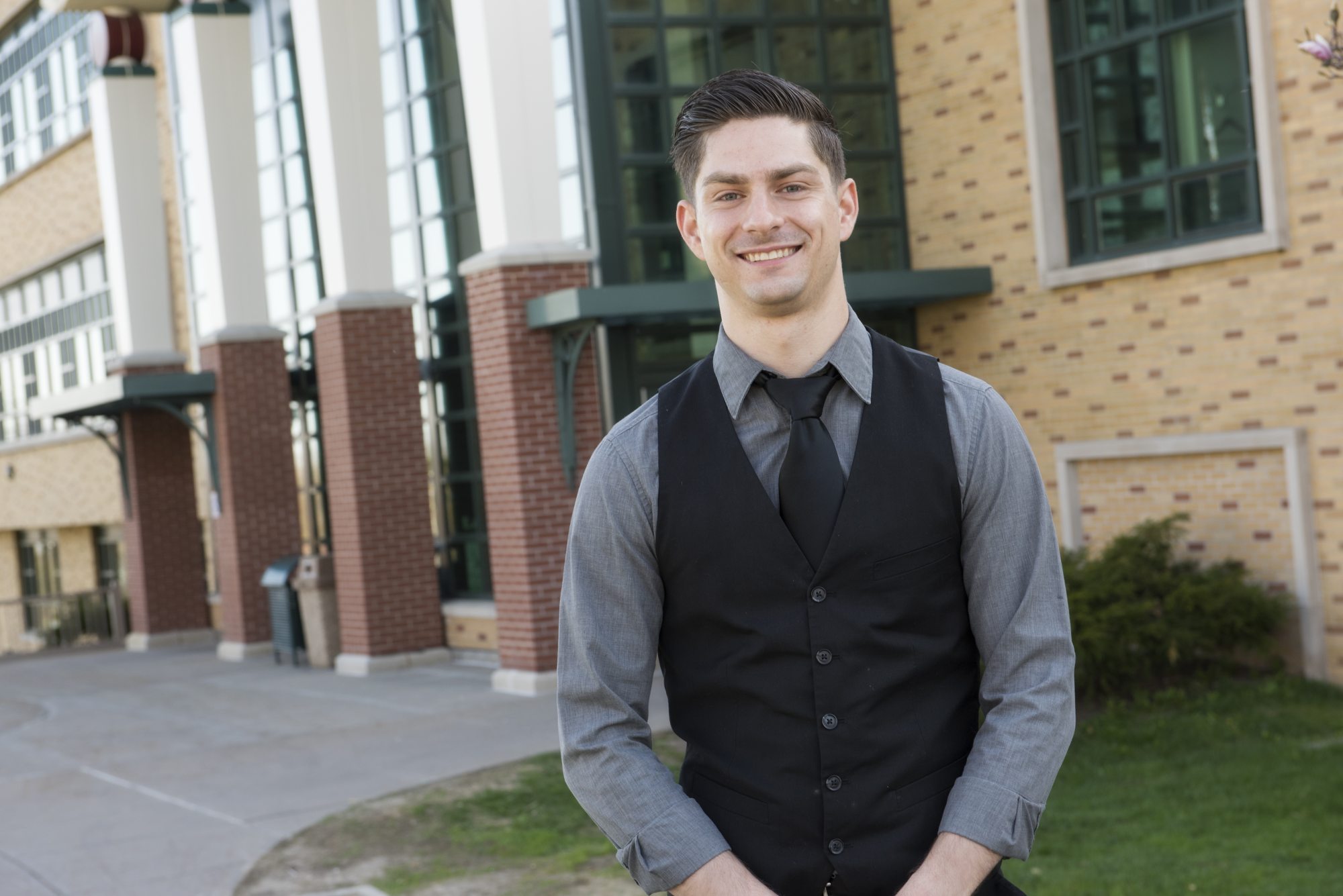 Student in front of Rich Hall