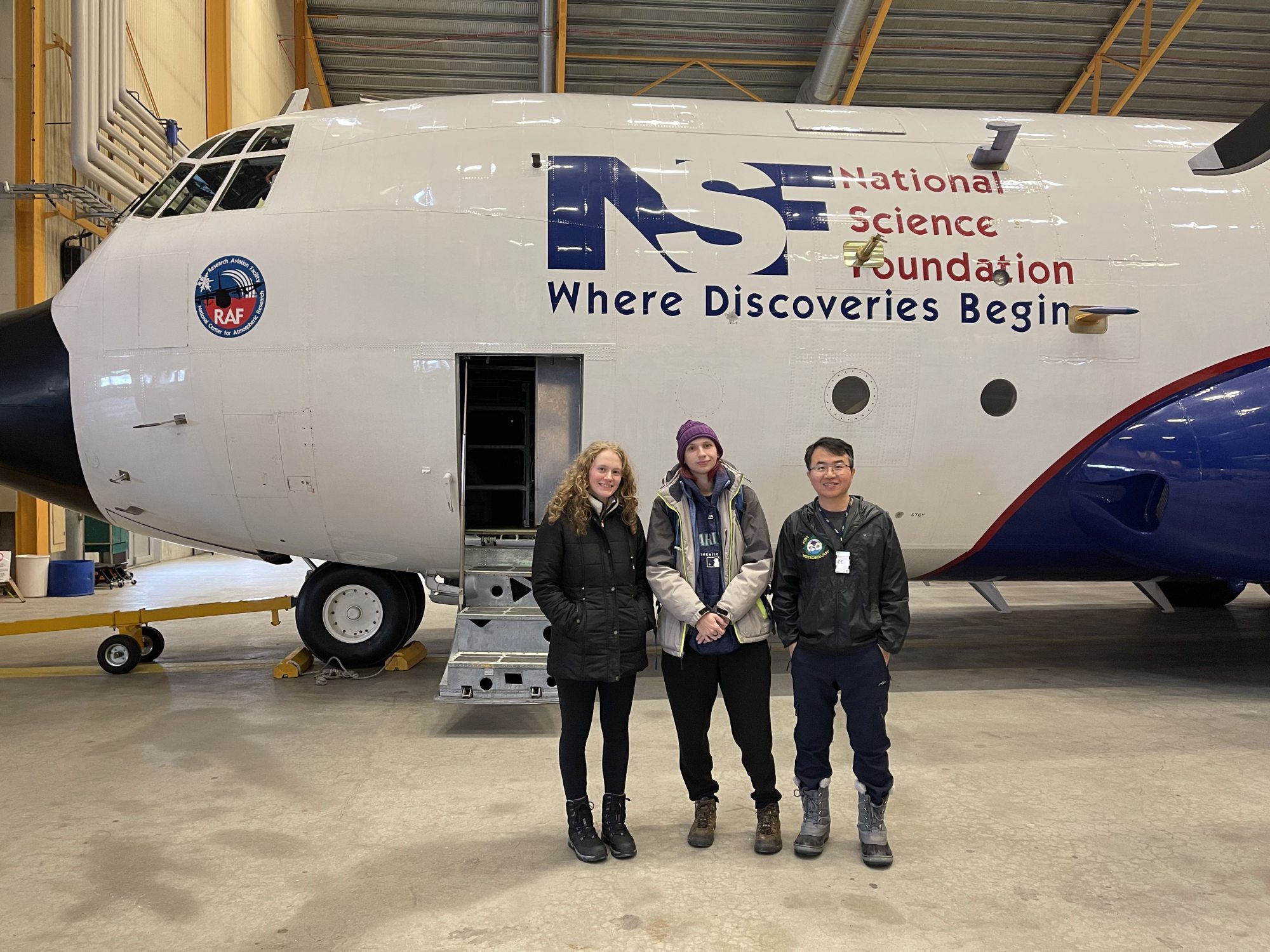 Oswego students Sarah Gryskewicz and Bee Lamsma, and Dr. Yonggang Wang stand in front of the NCAR C-130 research aircraft.