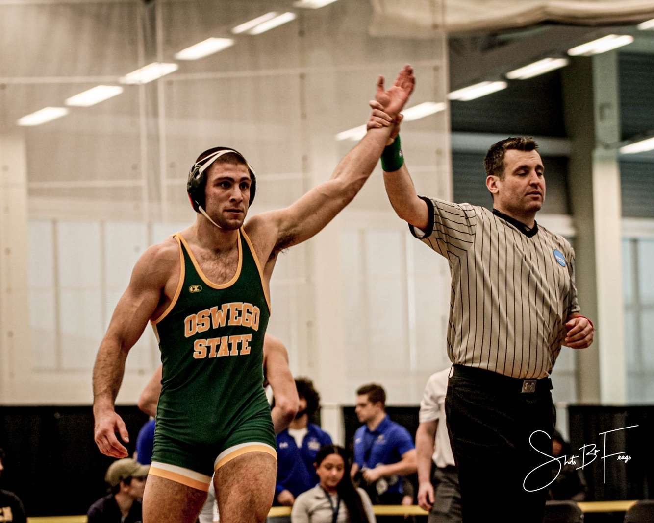 Wrestler Charles Grygas with his hand raised in victory