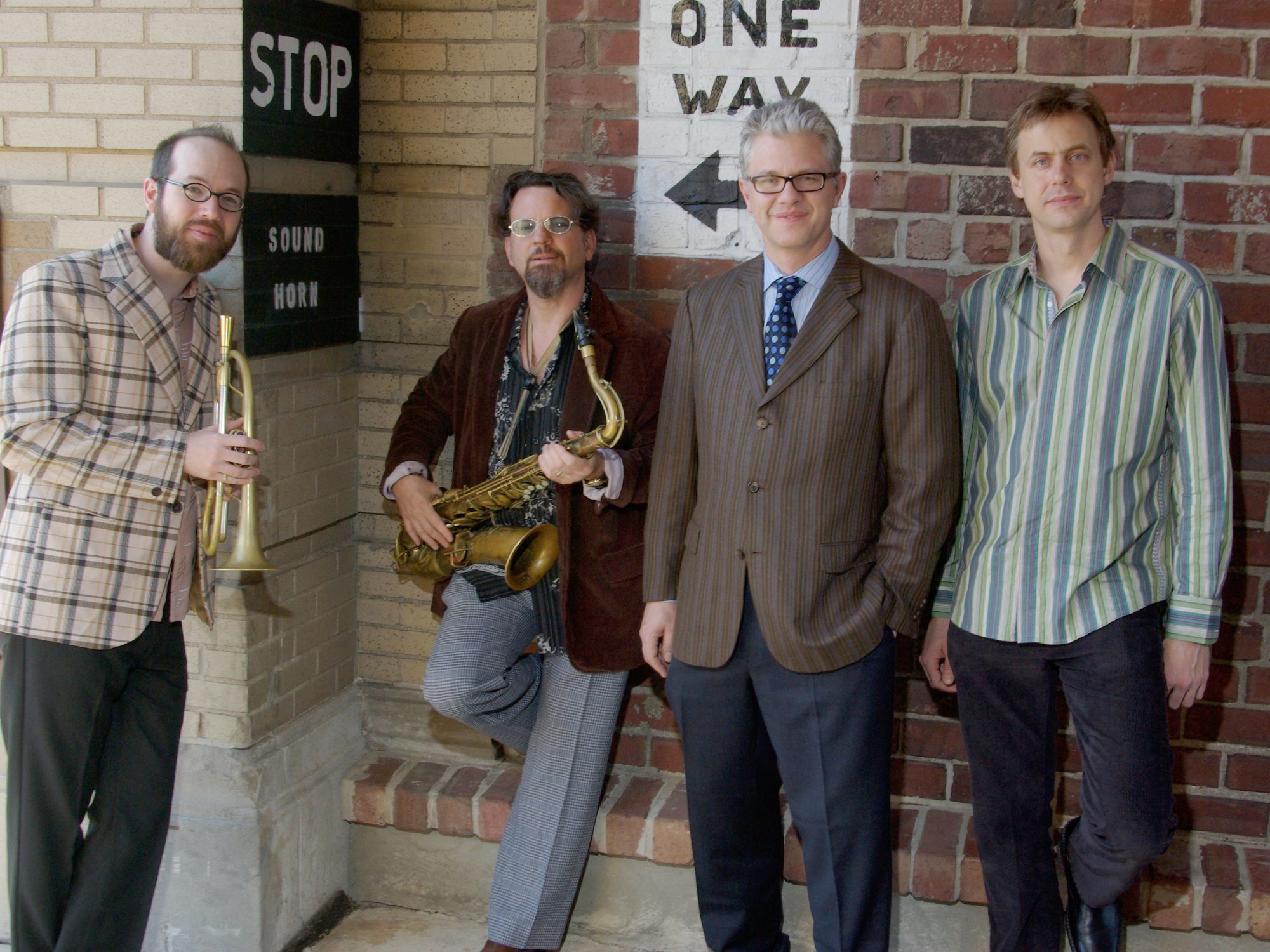 Matt Wilson Quartet standing against a wall
