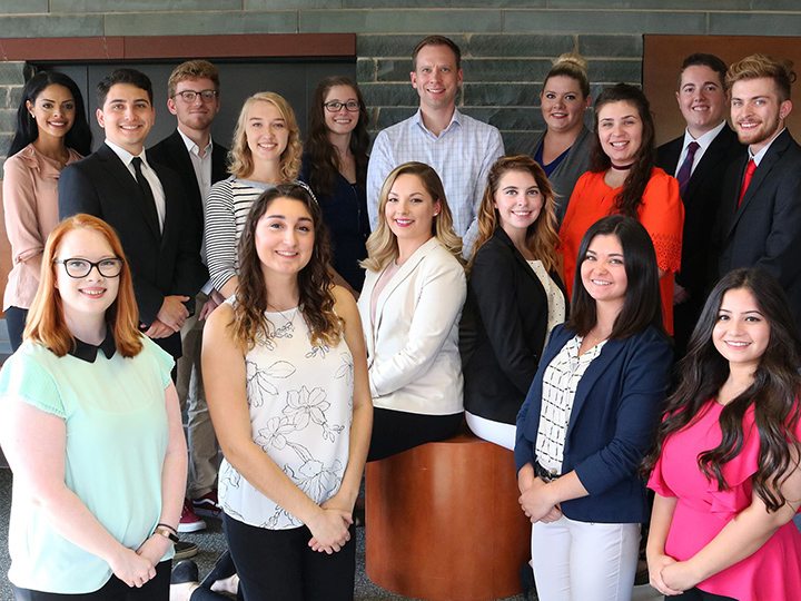 Group shot of students who organize Media Summit with adviser Michael Riecke