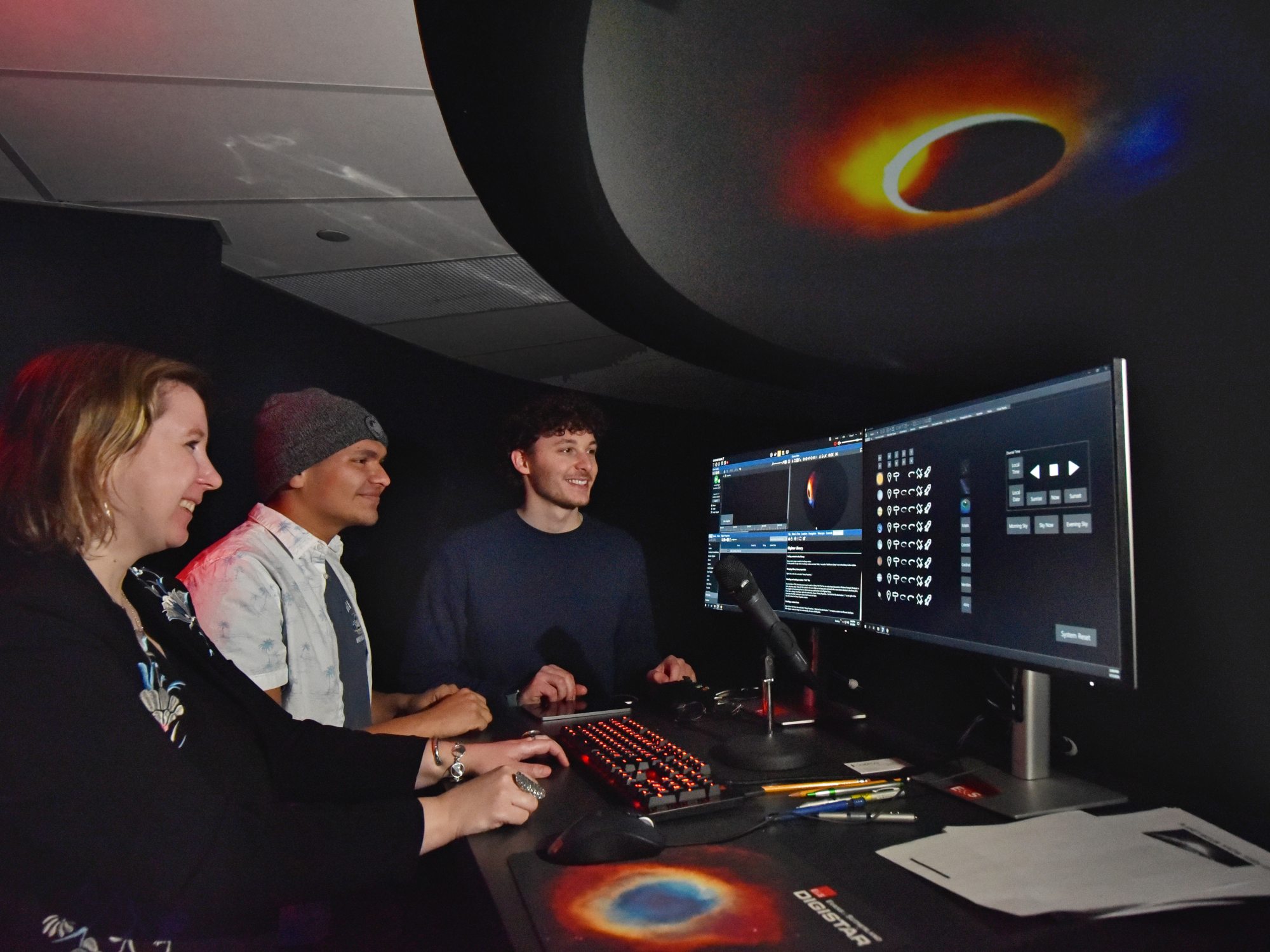 From left, SUNY Oswego planetarium director Natalia Lewandowska speaks with students Jason Ruiz and Stephen Miskovsky about putting together planetarium shows.