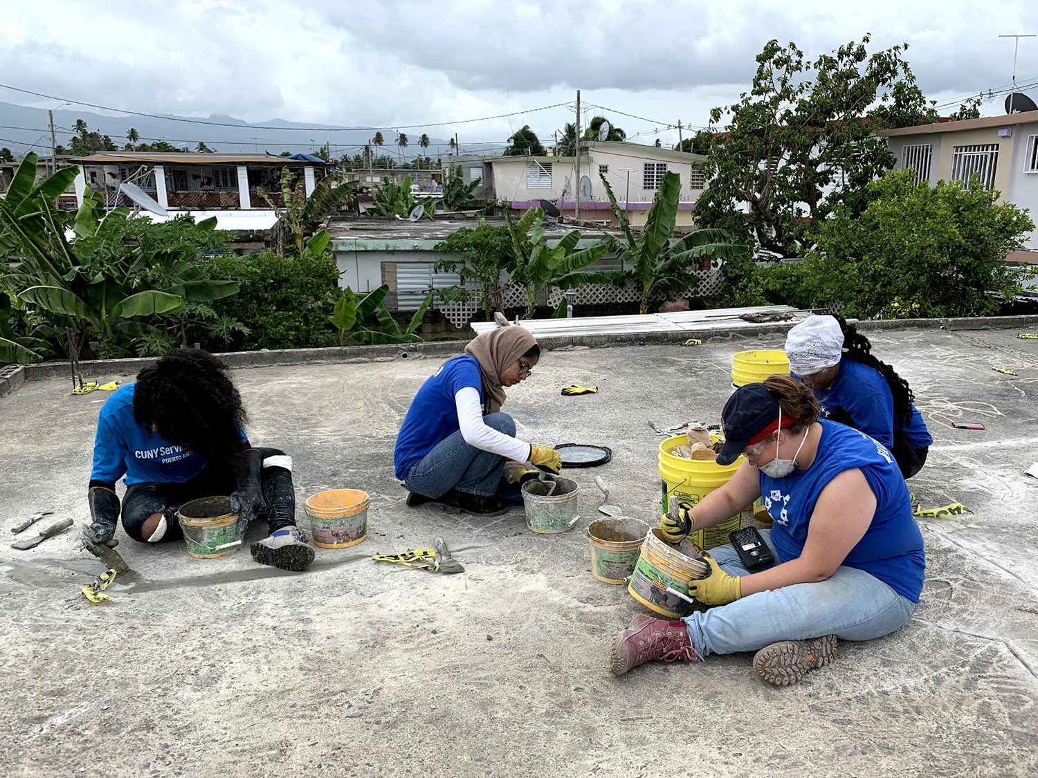 Students work on patching a roof in Puerto Rico