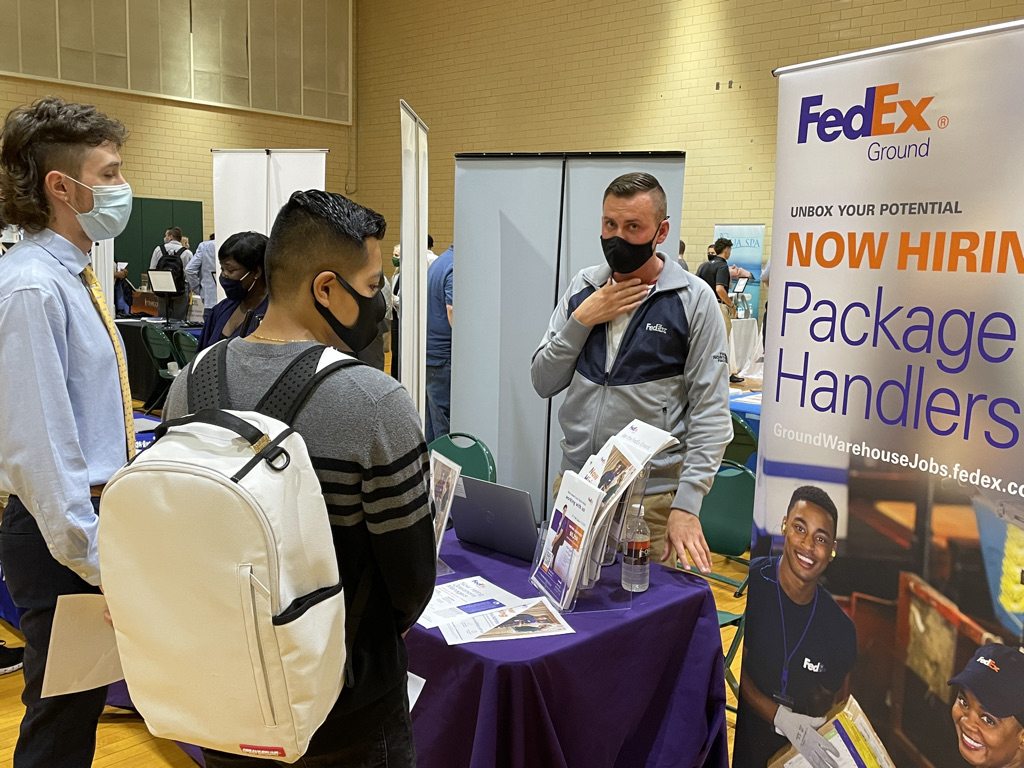 Student meet with a FedEx representative at a previous career and internship fair
