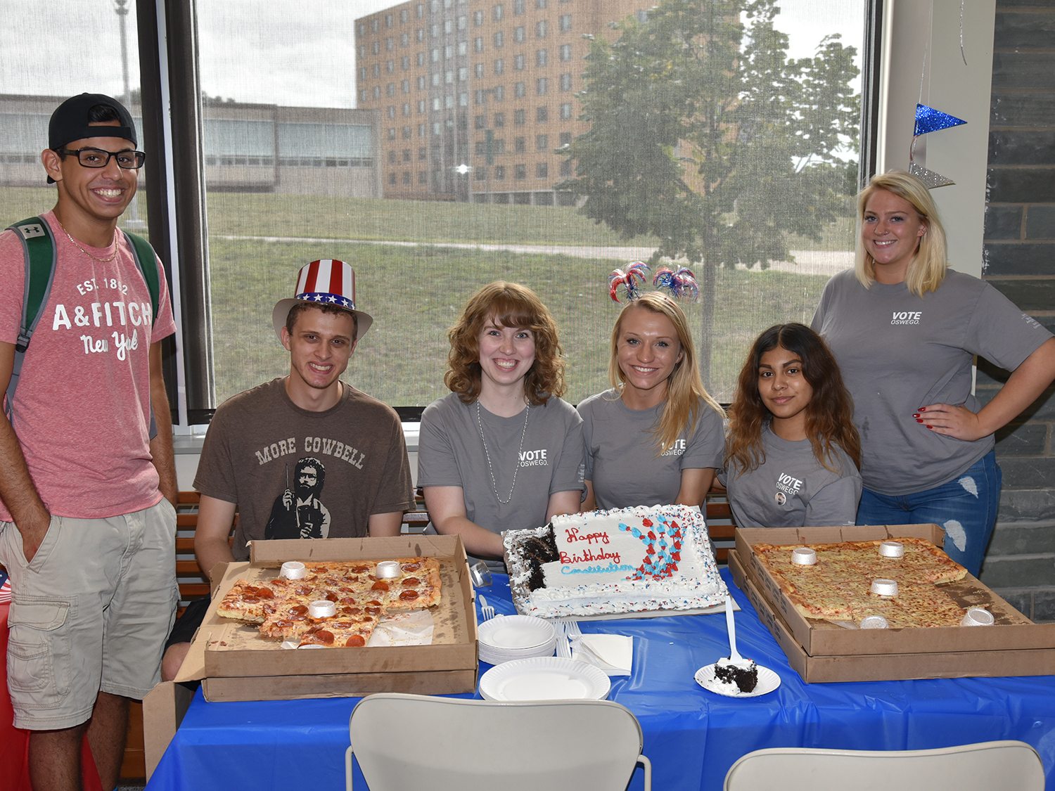 Students with pizza and cake at Constitution Day party in 2018