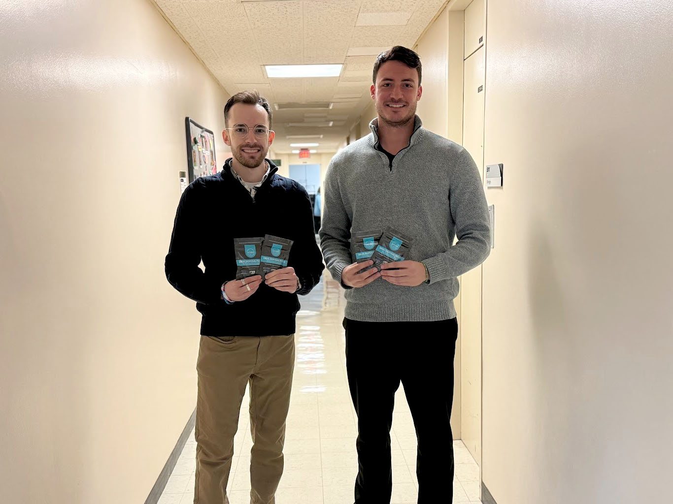Care Coordinators Kyle McCauley (left) and Dylan Lavner (right) from the Oswego County Prevention Coalition pose with the drug deactivation bags, which are now available on campus.