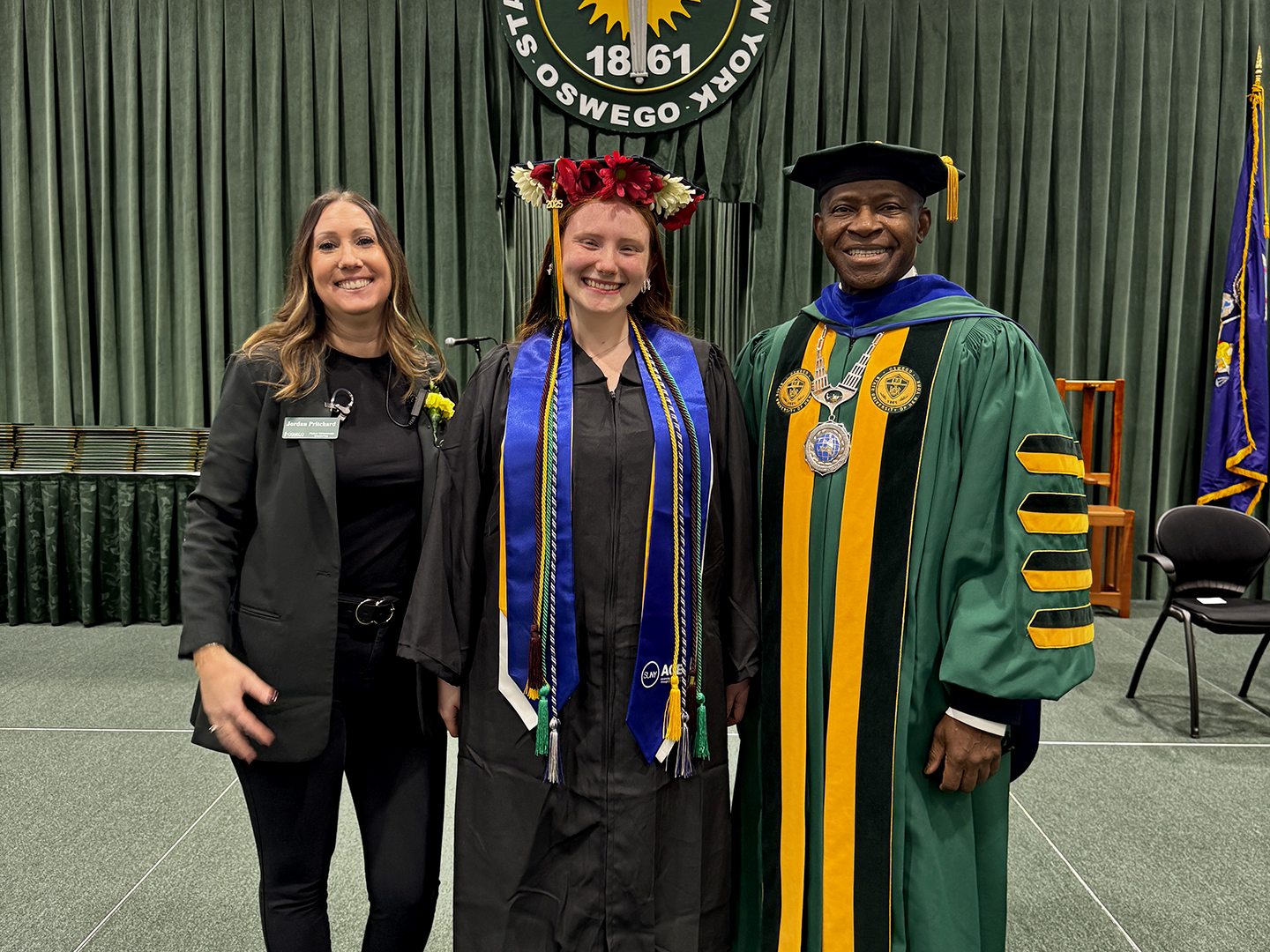 ACE Program Director Jordan Pritchard with the program's first graduate, Emily Colledge, and SUNY Oswego President Peter O. Nwosu.