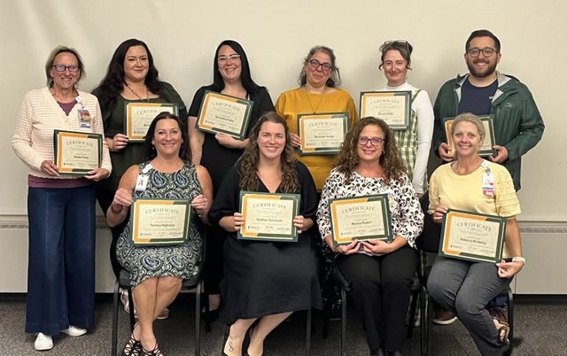 Oswego Health managers show certificates for completing training
