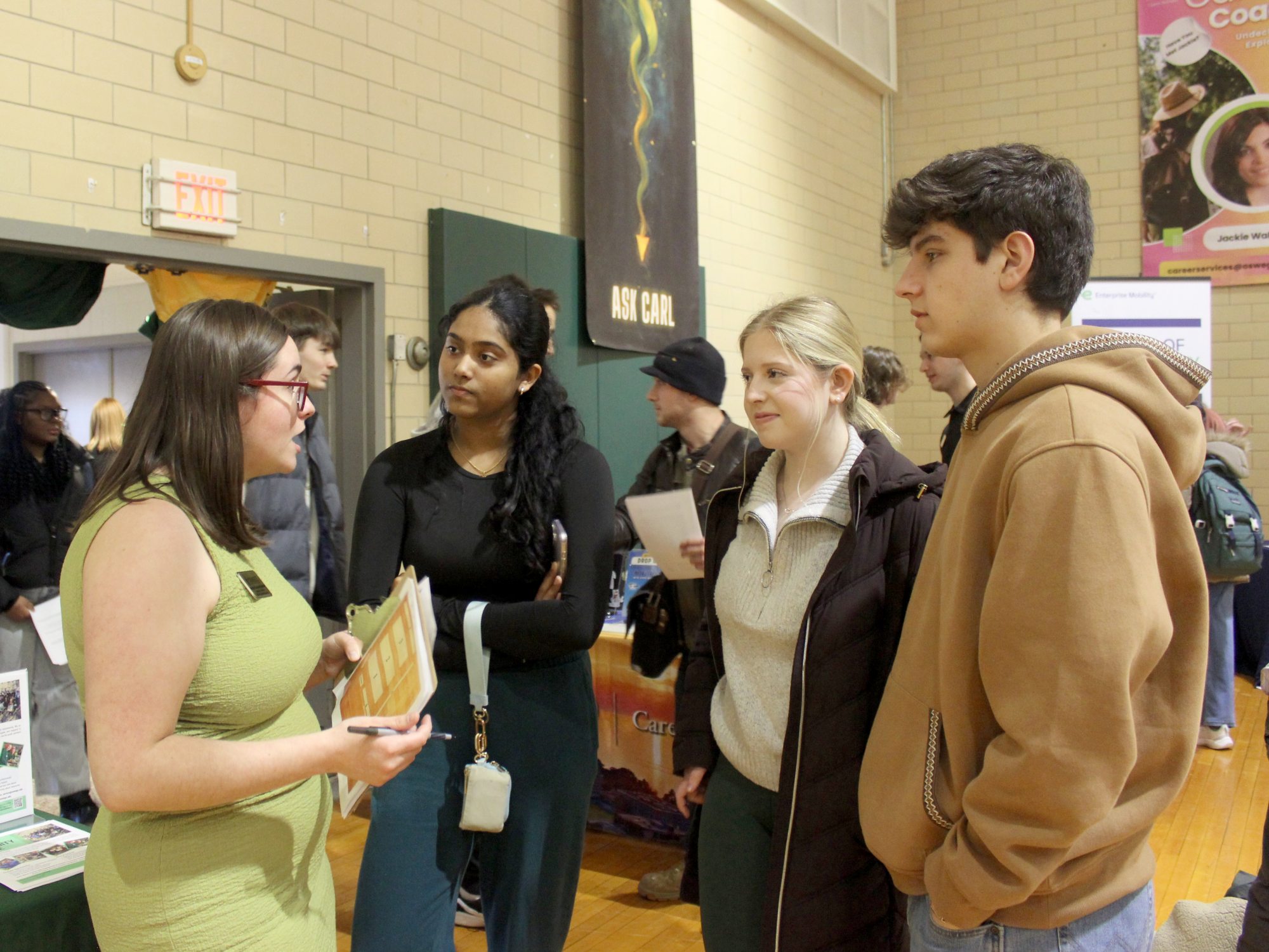 Internship coordinator and SUNY Oswego graduate Maureen (Mo) Buchanan (left) speaks with students at the spring Career Fair