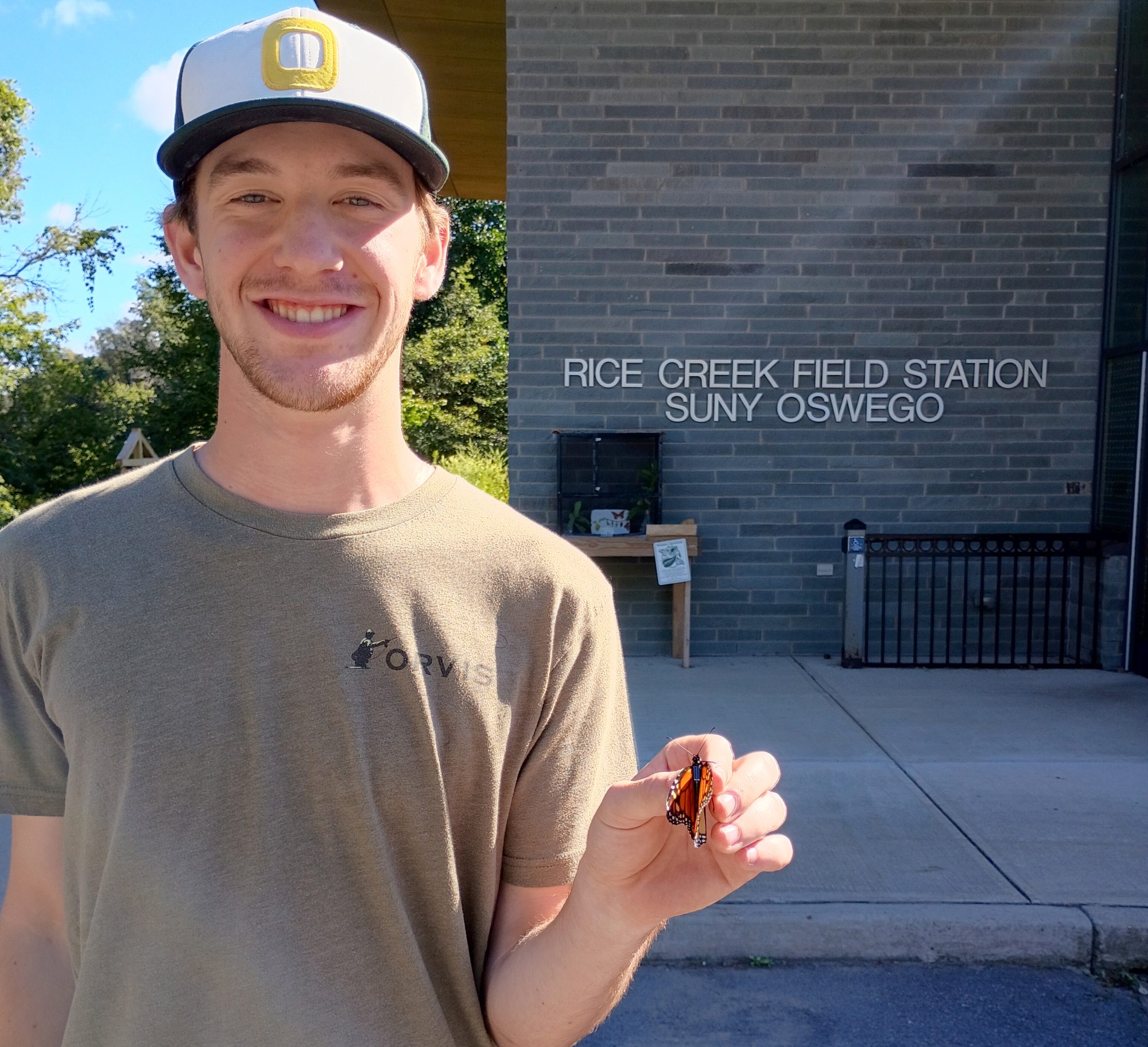 Dashel Hiller holds a tagged monarch butterfly