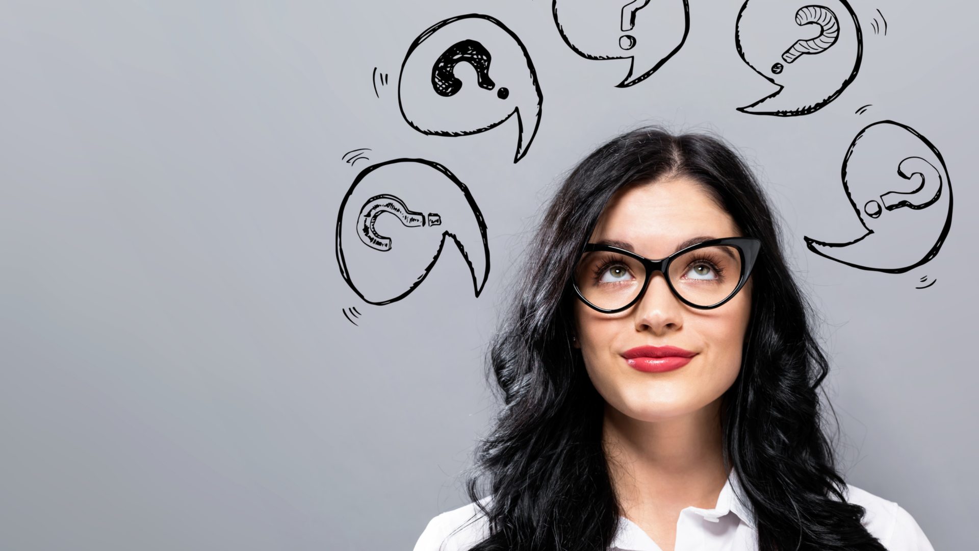Woman surrounded by question marks.