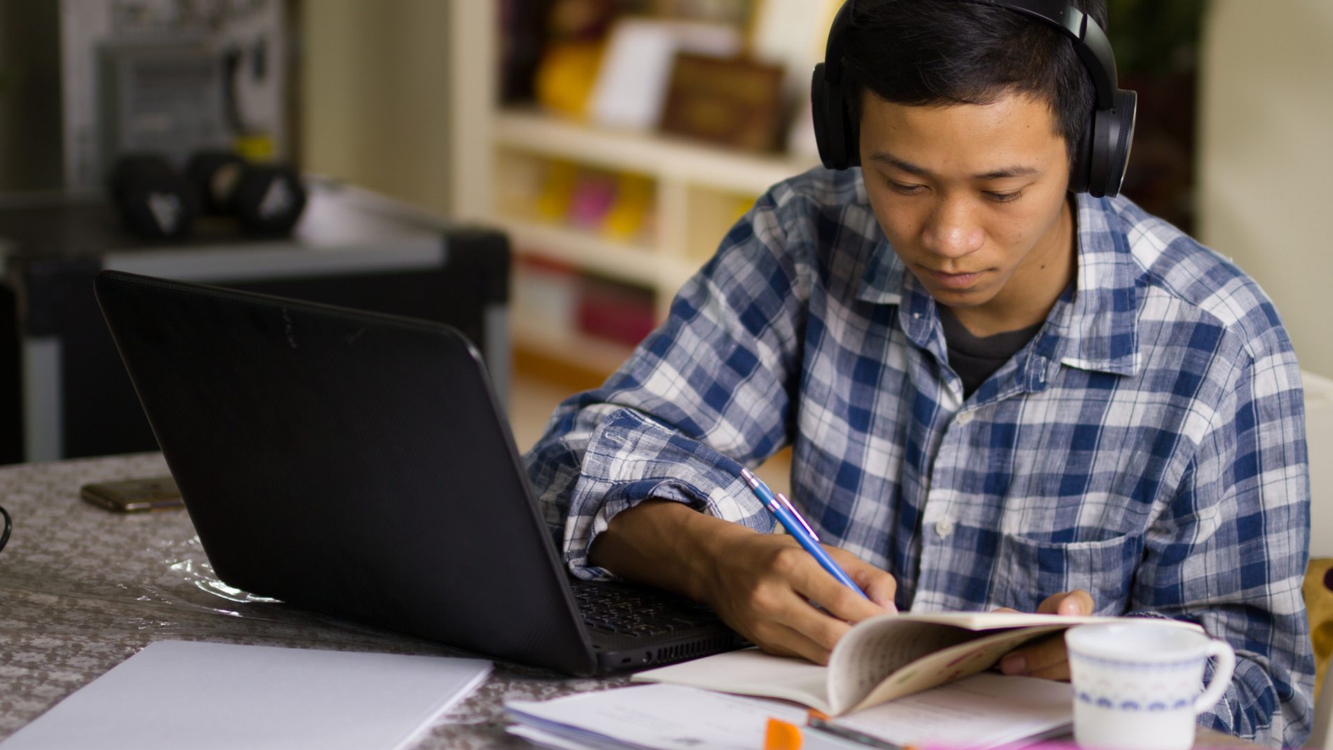 Young man studies online from home. 
