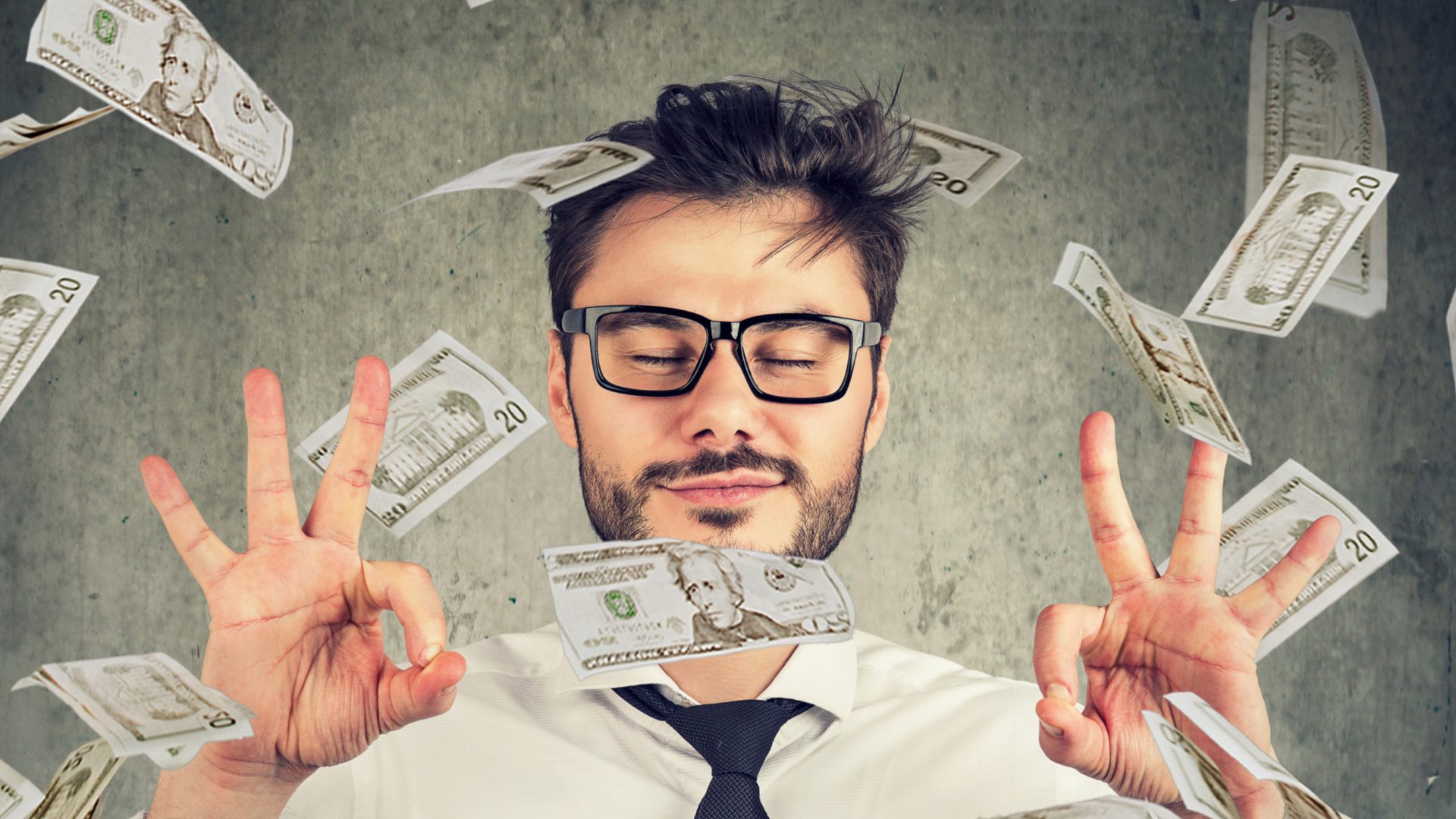 Young man surrounded by 20 dollar bills. 