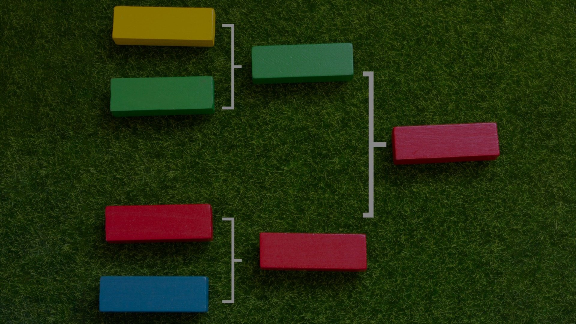 Colorful blocks that are laid on a green turf background. They are in a bracket layout reminiscent of a sports tournament.