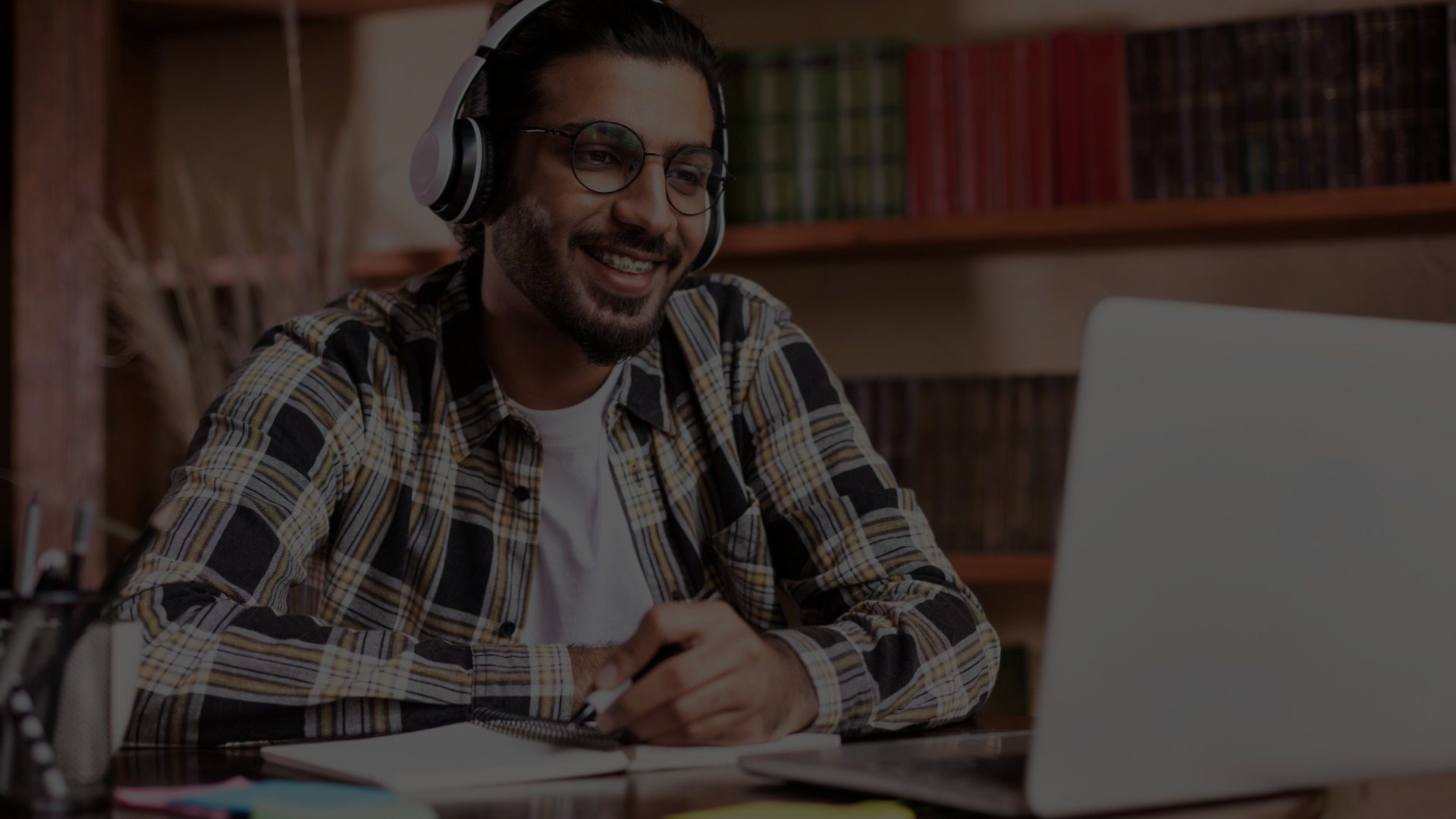 A man meets online with a tutor. 