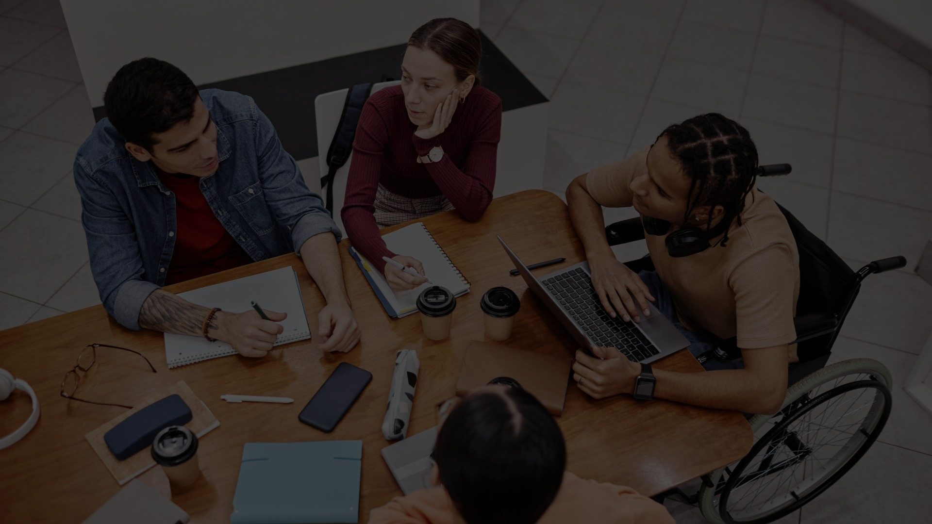 A group of college students works together at a table.