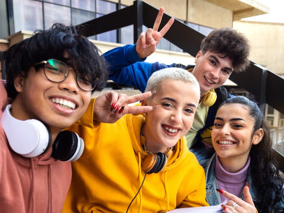 A group of college students smile and pose for the camera. 