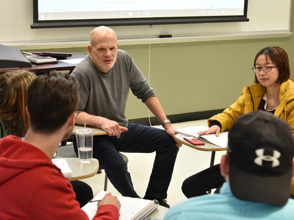 Dr. Andrews in a discussion with students
