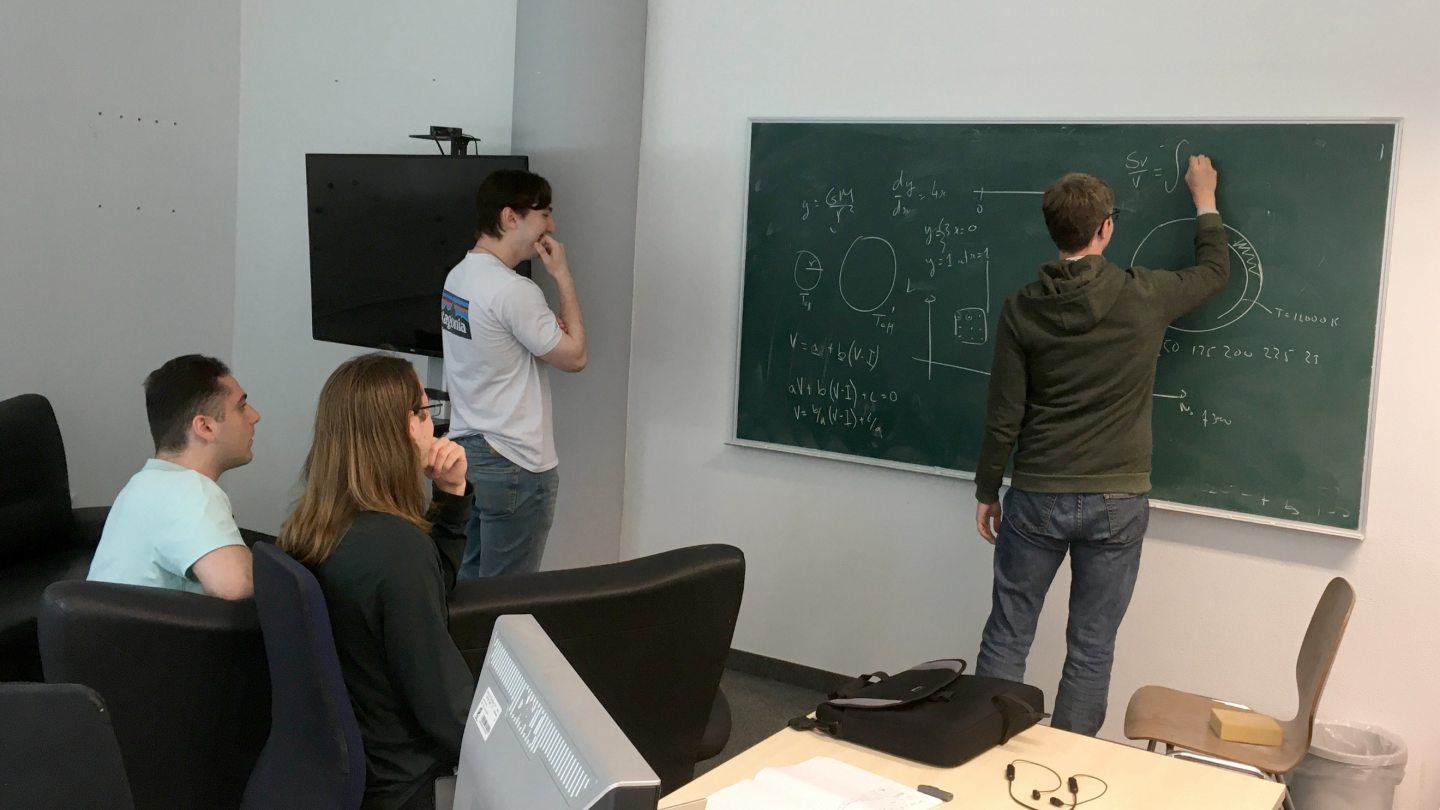 Students in a classroom studying astrophysics