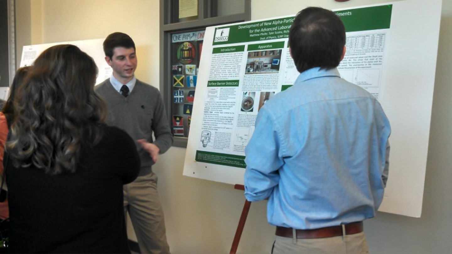 A student with his poster presentation about nuclear energy