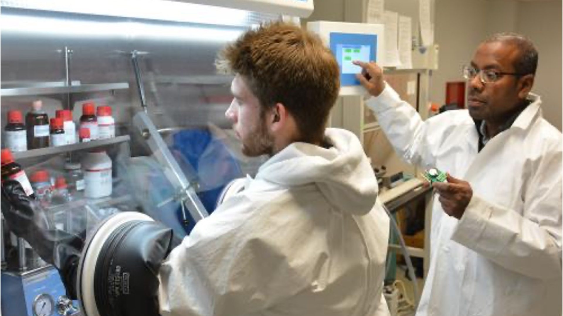 Two people wearing lab coats in a lithium ion battery lab
