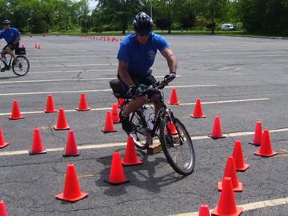 A person riding a bike through a path determined by road cones