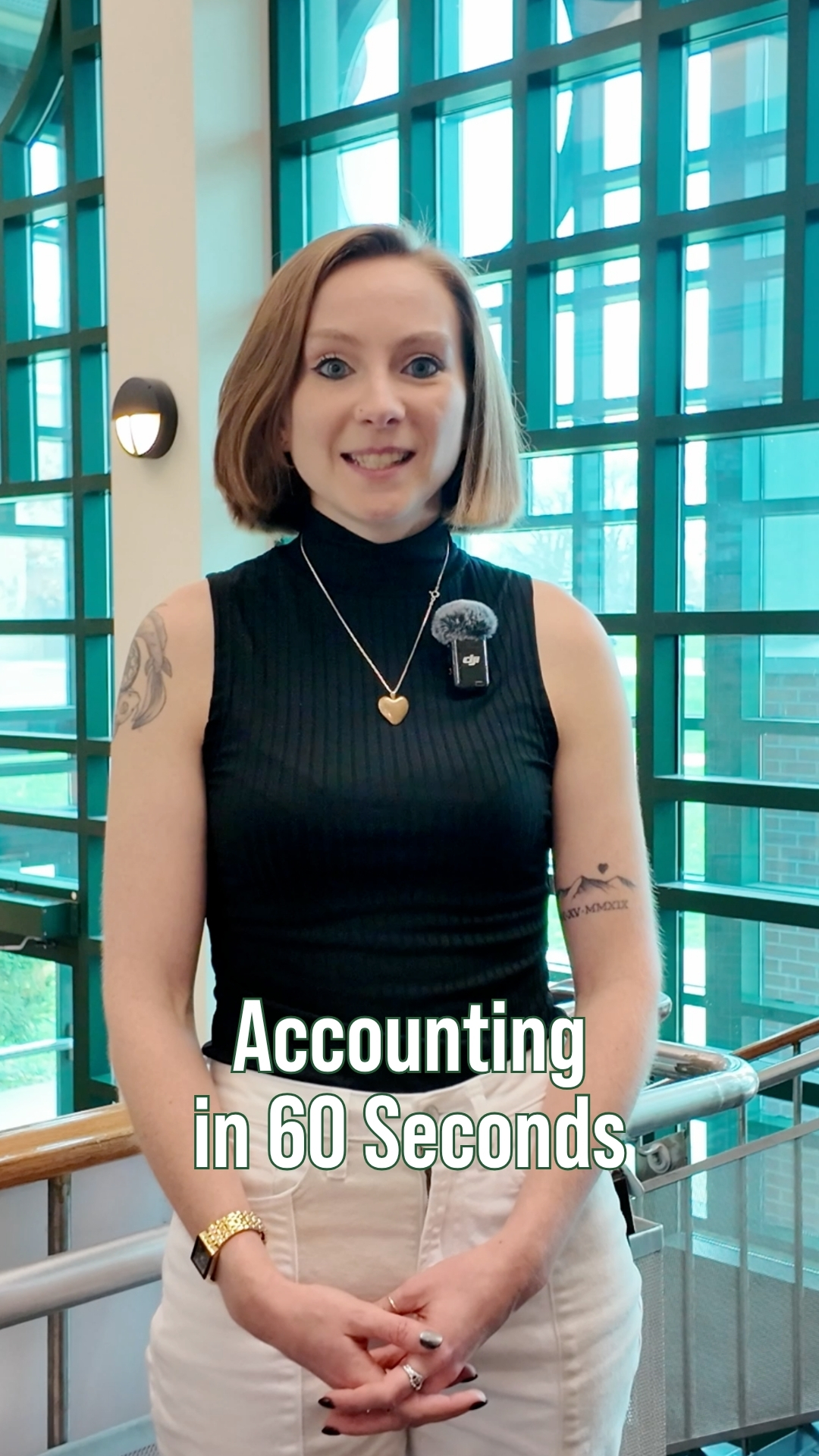 A student stands inside Rich Hall with large windows, with on-screen text reading “Accounting in 60 Seconds.”