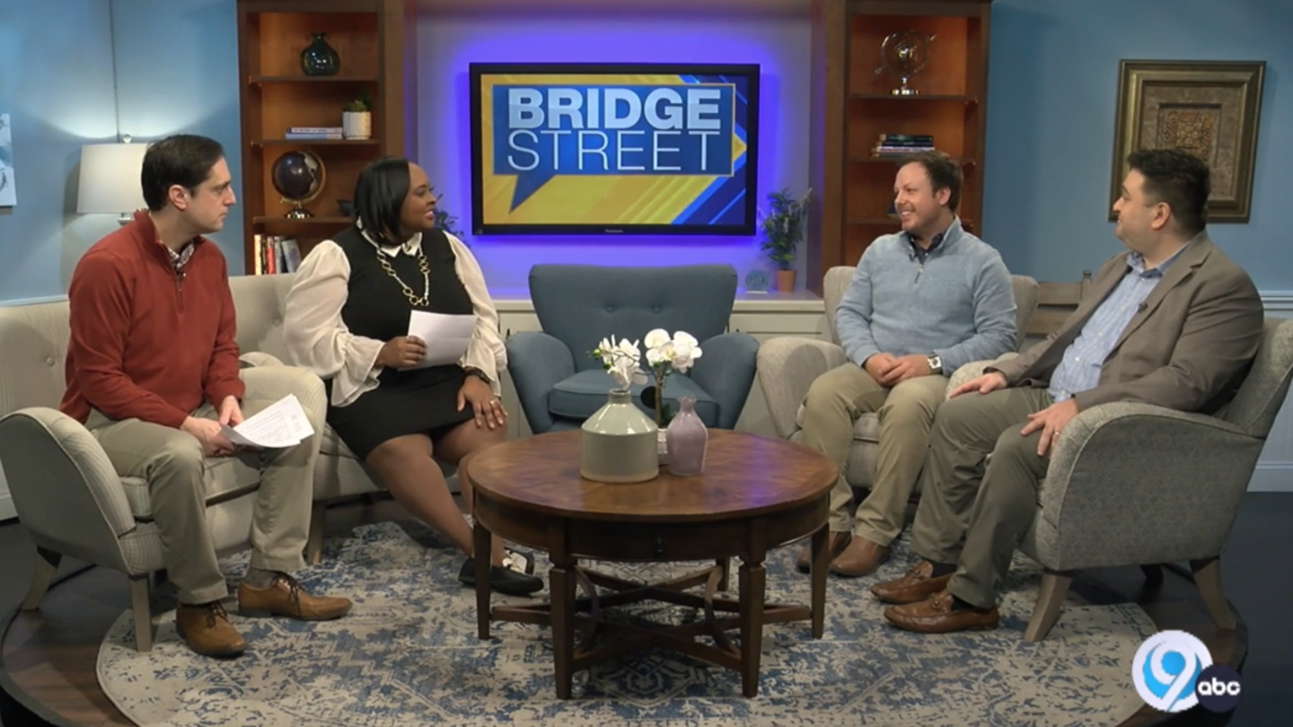 faculty and student on local television station