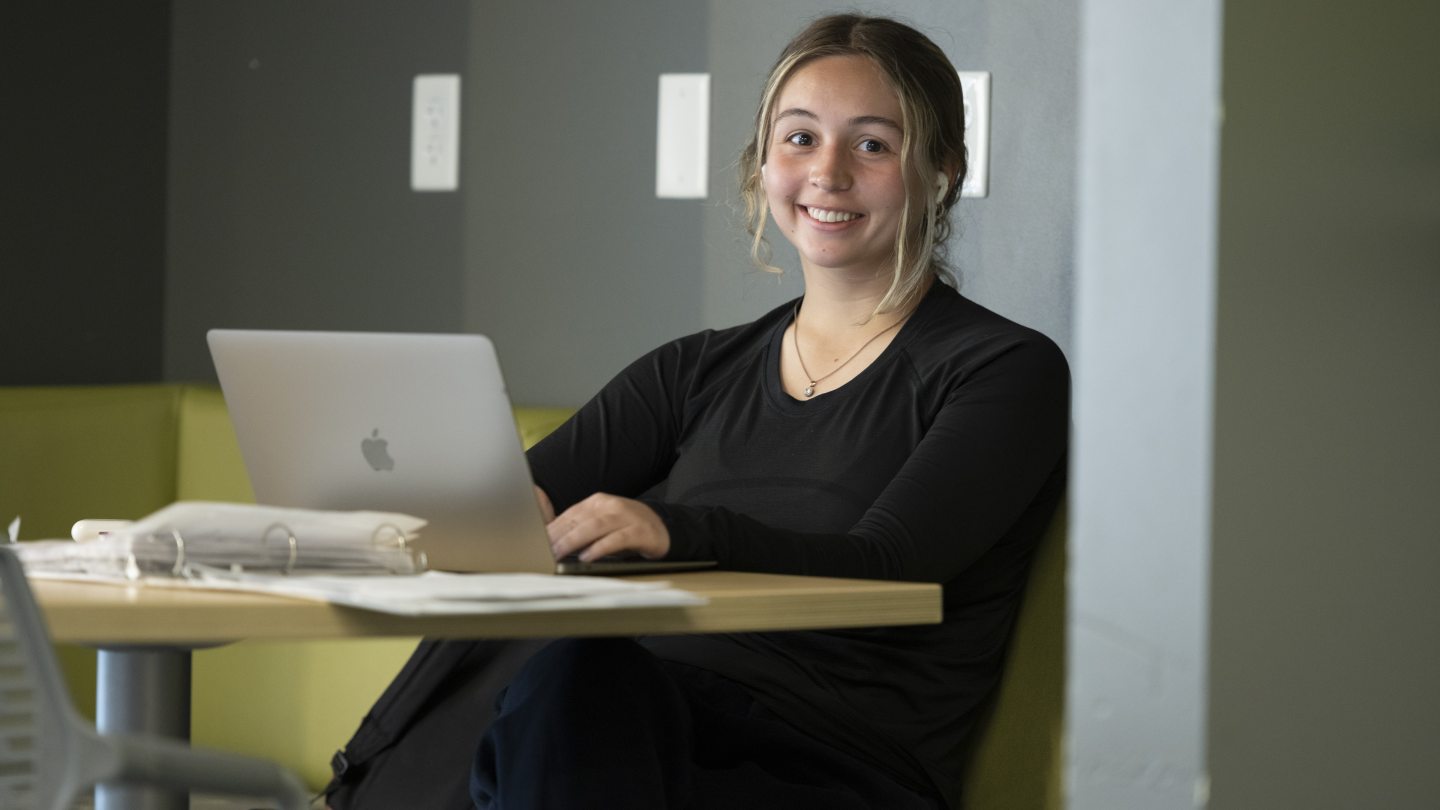female student working on a laptop