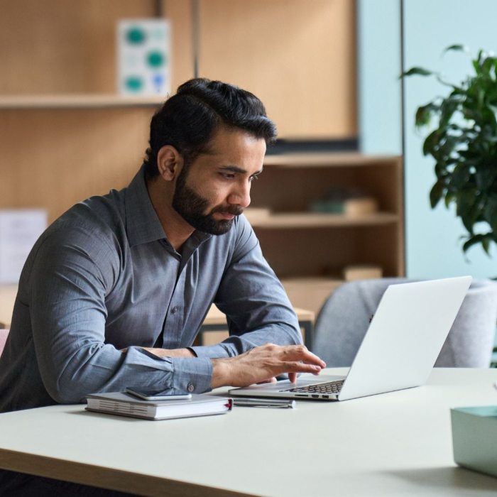 male student studying on a laptop