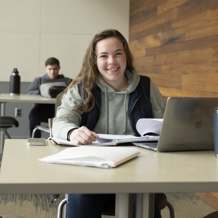 female student working on a laptop