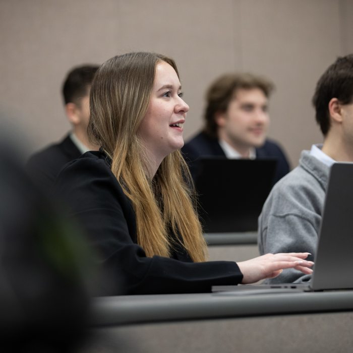 Public accounting students participate in a classroom discussion while using laptops.