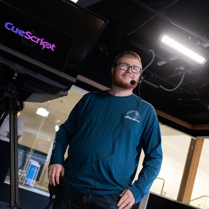 Broadcast and digital media student in a television production studio.