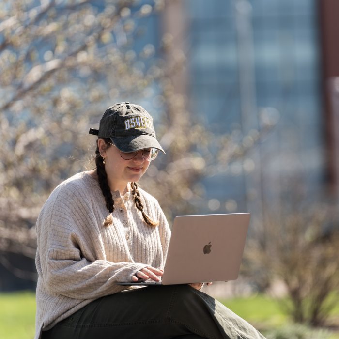 student working on a laptop outside