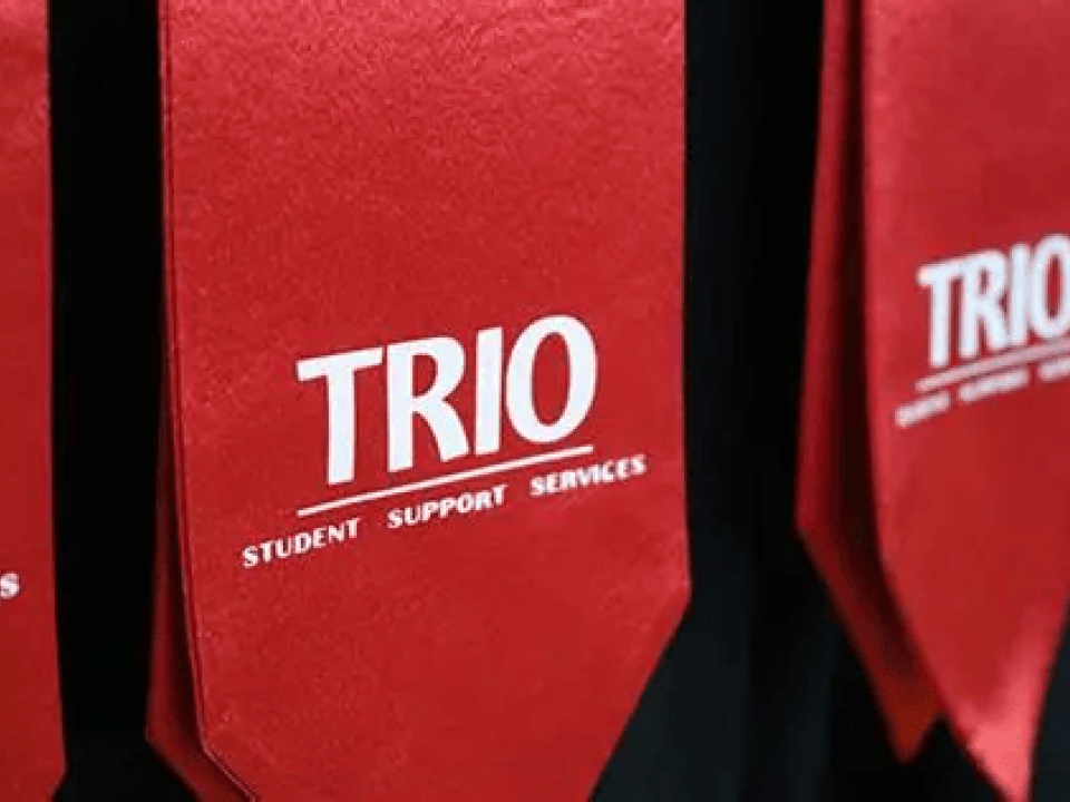 Fabric stole with ‘Trio’ lettering across the front