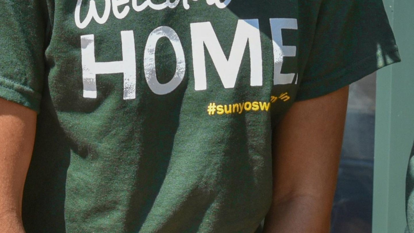 Close-up of a green &quot;Welcome Home&quot; shirt