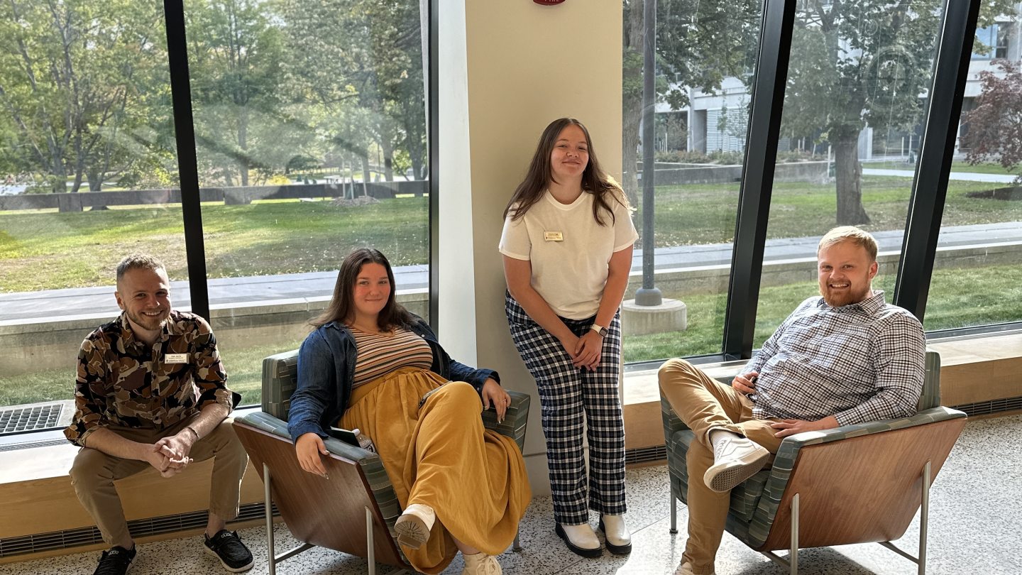4 Residence Hall Directors and Assistant Hall Directors sitting in Tayler Hall