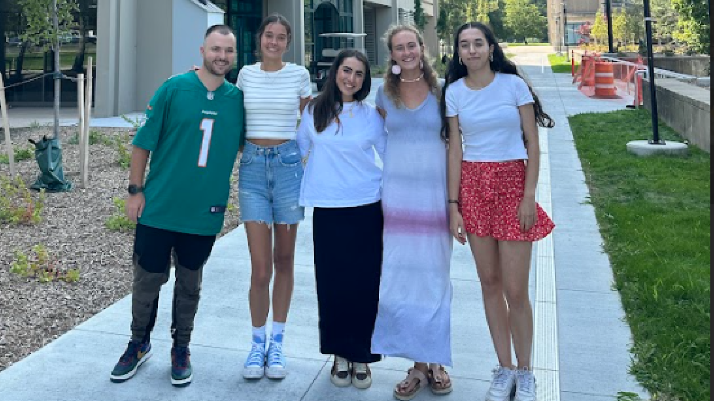 Students posing for a photo in front of Culkin Hall 