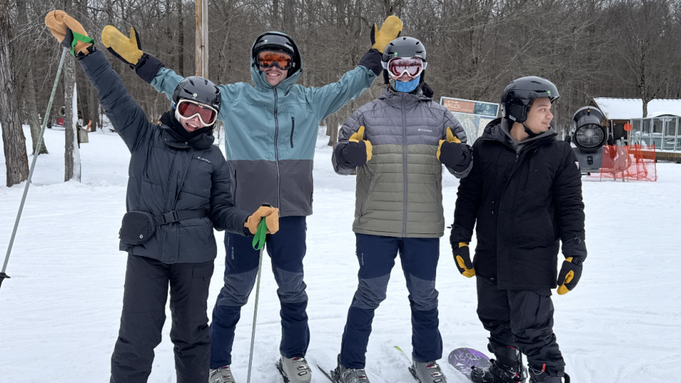 Four students at a skiing trip. 