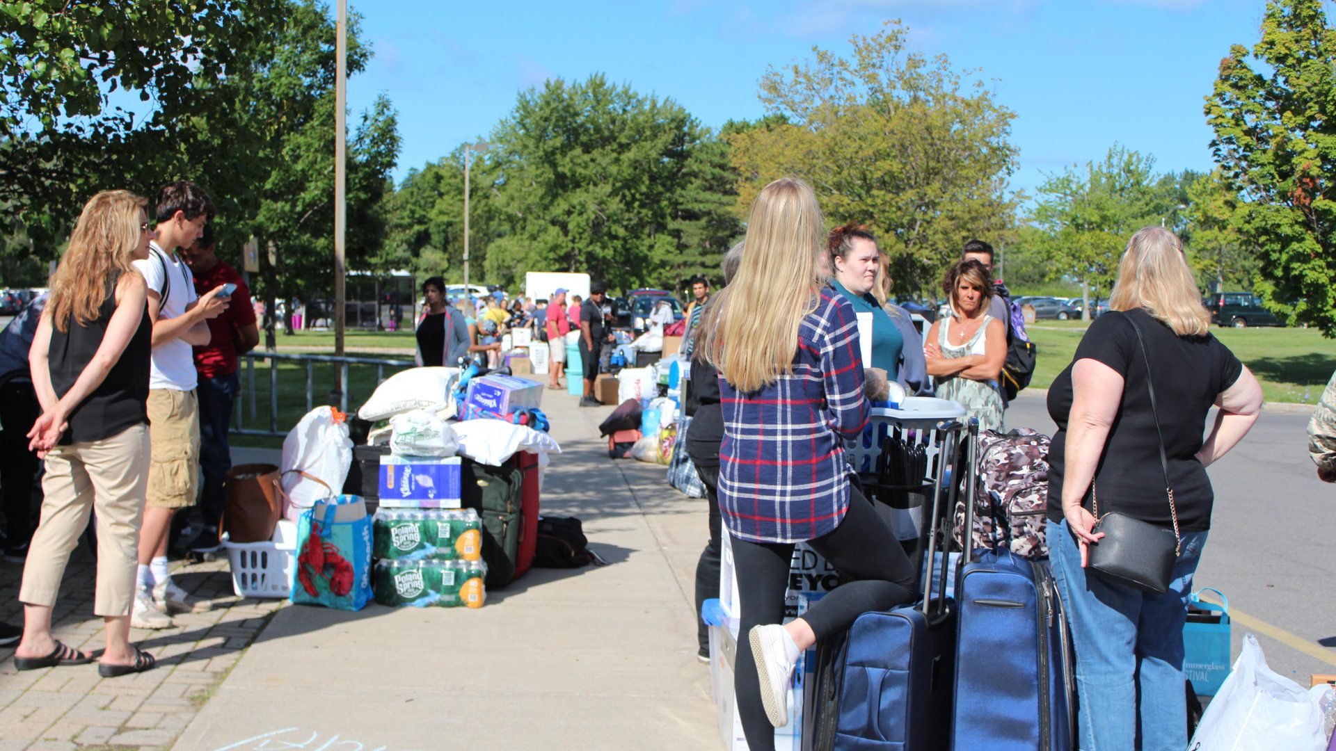 families outside a residence hall, moving in their students