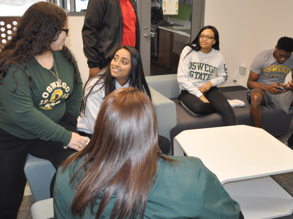 A group of students sitting in a lounge talking