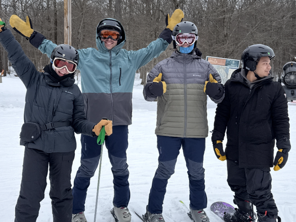 Four students at a skiing trip. 