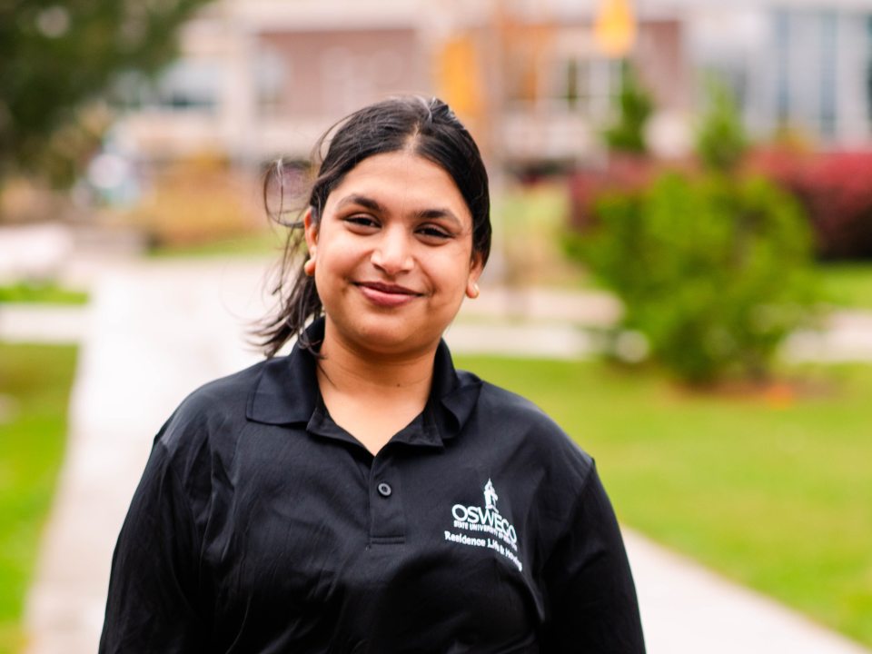 RA in a polo on a side walk