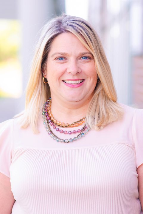 Headshot of Sara Rebeor in a pink shirt. 
