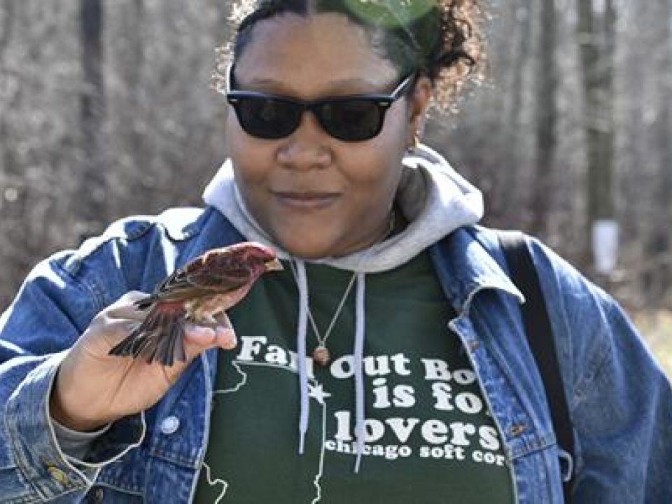 student with bird sitting on hand