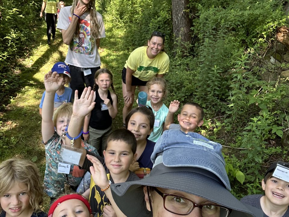 A group of kids in the forest with their instructor